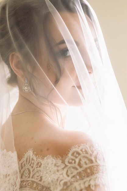 a woman wearing a wedding dress and veil