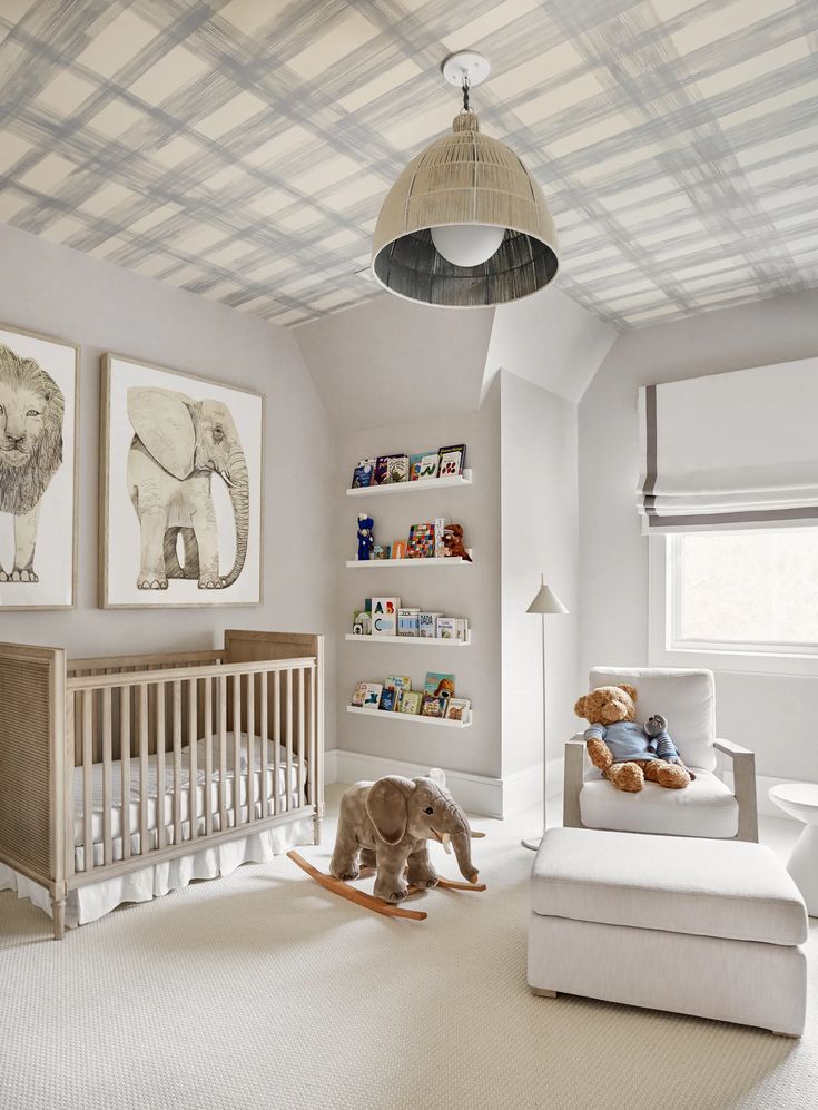 a baby's room with white walls and furniture