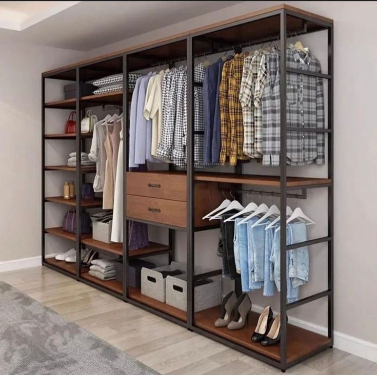 an open closet with clothes and shoes on shelves in front of a carpeted floor