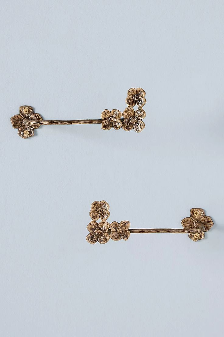 two pairs of gold tone flower clip on earring posts, one in the shape of flowers