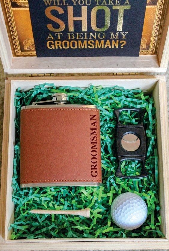 a golf gift set in a box with a leather flask case and two golf balls