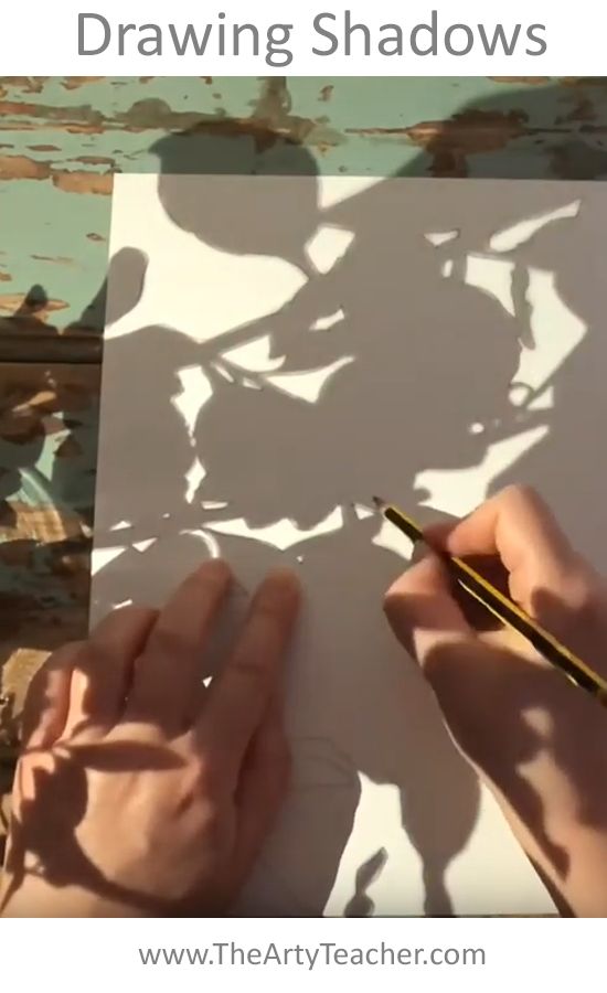 someone is drawing shadows on paper with their hands