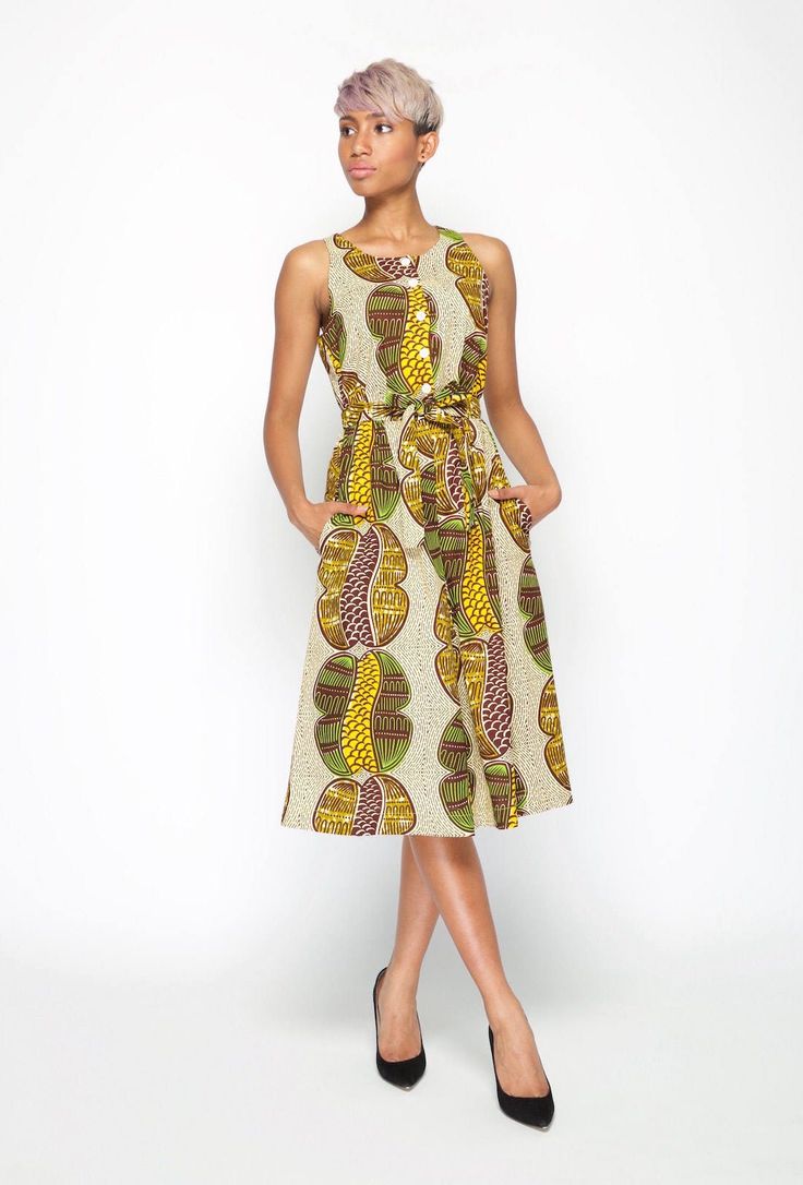 "This sleeveless A - line shaped print dress, is made with quality Dutch Hollandaise Cotton print, also known as African print. It features, front upper bodice button stand, inverted pleat bottom skirt, side pockets, elastic waist with self tie belt. Dress length falls below knee length.  A timeless trans-seasonal cocktail dress suitable for all occasions. Made In Australia. Model wears a size: S and is 5ft 6\" tall Fabric:  100% Cotton Care: Cold hand wash with mild soap. Do not bleach/soak or Casual A-line Dress With Abstract Print, Casual Sleeveless Maxi Dress With Abstract Print, Printed Sundress Midi Dress For Daywear, Casual Printed Patterned Sleeveless Dress, Casual Patterned Printed Sleeveless Dress, Casual Sleeveless Bold Print Dress, Casual Sleeveless Printed Dress, Sleeveless Spring Dresses With All Over Print, Spring Sleeveless Dress With Bold Print