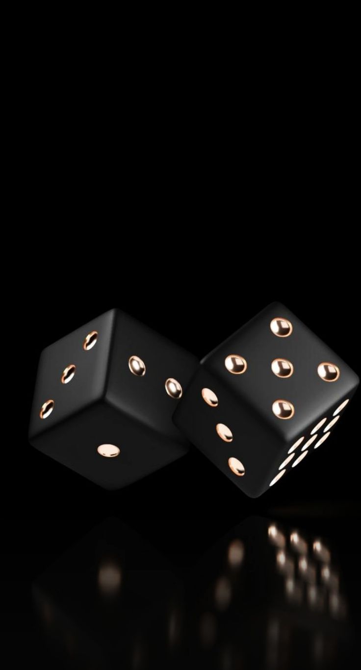 two black dices with gold dots on the sides are facing each other in front of a black background