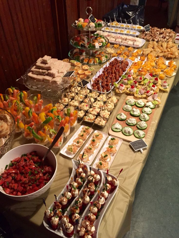 a buffet table filled with lots of different types of desserts and pastries on it