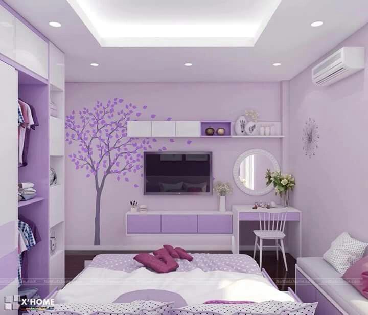 a bedroom decorated in purple and white with a tree painted on the wall above the bed