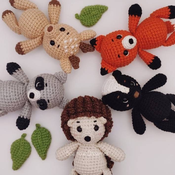 crocheted stuffed animals are arranged on a white surface