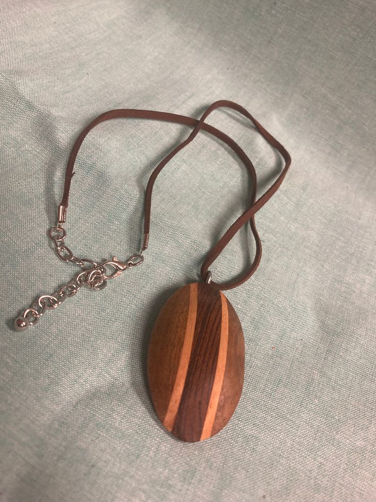 Turned wooden pendant Brown Pendant Necklace With Large Pendant, Brown Necklace With Large Round Pendant, Brown Necklace With Large Pendant For Gift, Brown Necklace With Large Pendant As Gift, Brown Wooden Pendant Jewelry, Brown Wooden Beads Pendant Necklace, Artisan Brown Necklace With Oval Pendant, Wooden Pendant Necklace For Gift, Brown Wooden Necklace Gift