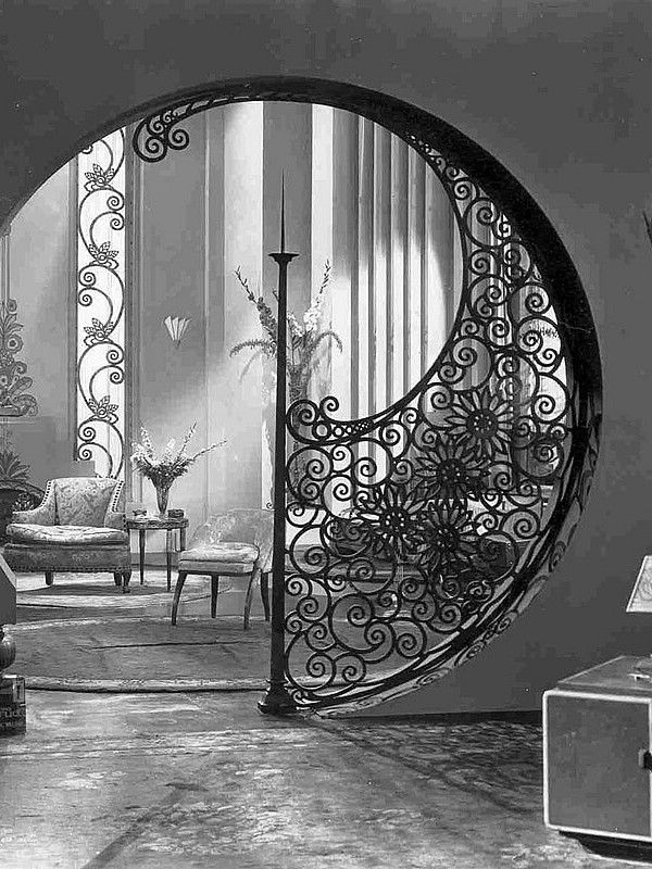 an ornate iron gate in the middle of a living room