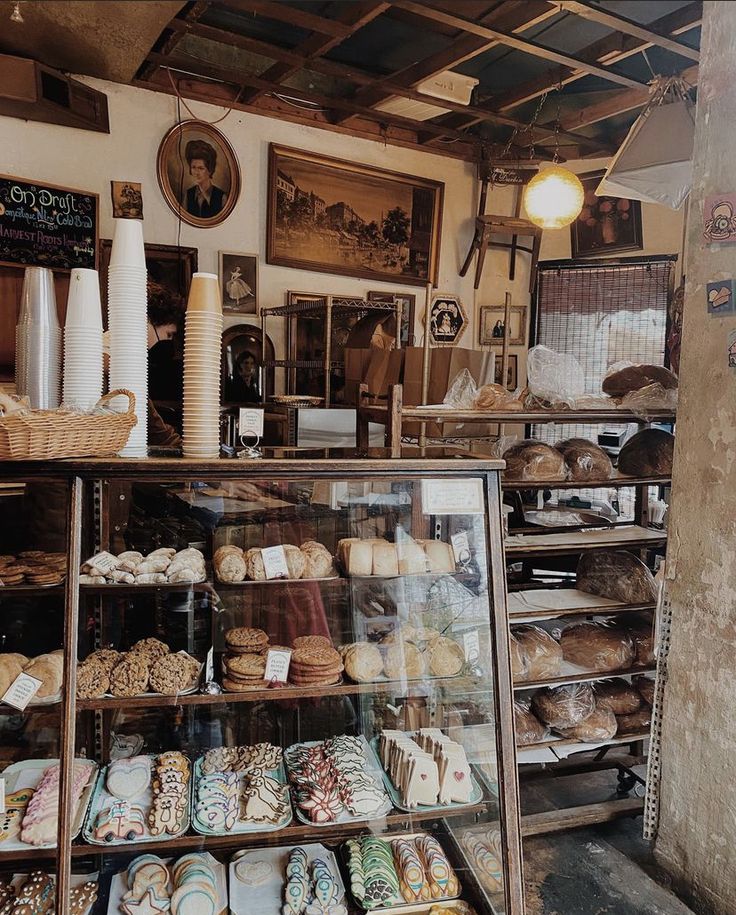 a bakery filled with lots of different types of breads and pastries on display