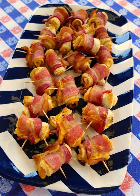 bacon and cheese skewers are on a blue and white plate with red and white checkered tablecloth