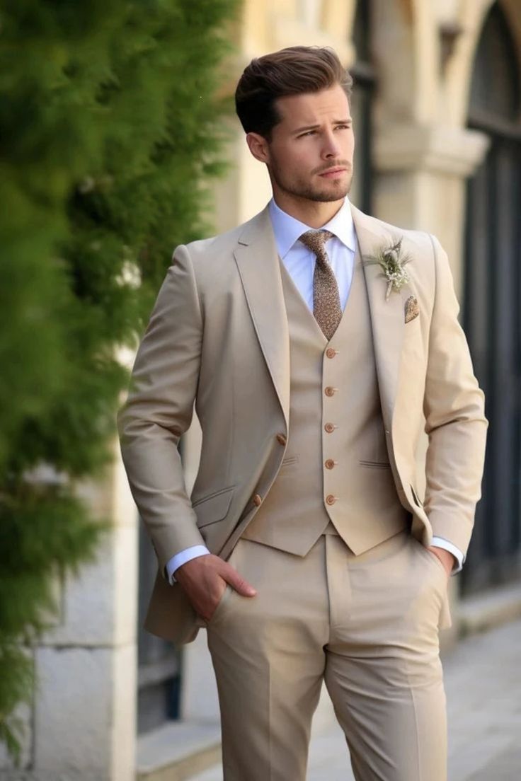 a man in a tan suit and tie standing on the street with his hands in his pockets