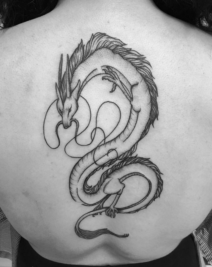 a woman with a dragon tattoo on her back