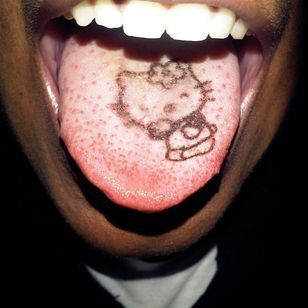 a person sticking their tongue out with a hello kitty on it