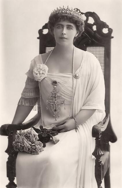 an old black and white photo of a woman wearing a tiara