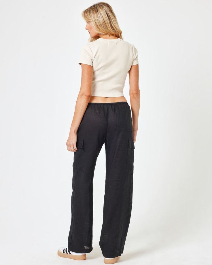 We love the cargo trend so much that we made our own! The Sundown Cargo Pants are showing up with style thanks to their mid rise, tie waist and generous wide leg. We didn't skimp on the pockets either. Wear them with your fave t-shirt or with the matching top for a complete set. Cargo Pant Pockets At Thigh Pocket on Butt Mid or High Rise Tie Waist Relaxed Leg Size XS-XL 100% Linen Like all delicates, shape, color and fit are best preserved if hand washed in cold water. Lay flat to dry. Style # S Casual Cropped Wide Leg Pants With Pockets, Casual Cropped Bottoms With Cargo Pockets, Black Cropped Bottoms With Pockets, Casual Cropped Cargo Pants With Pockets, Casual Cropped Bottoms With Belt Loops, Cropped Black Bottoms With Pockets, Wide Leg Cargo Pants For Elevated Casual Occasions, Elevated Casual Wide Leg Cargo Bottoms, Elevated Casual Wide Leg Cargo Pants