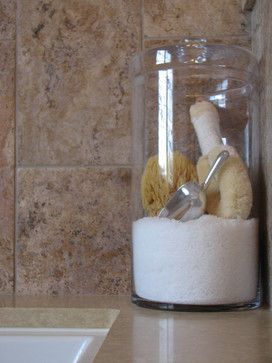 a glass jar filled with stuffed animals on top of a counter next to a sink