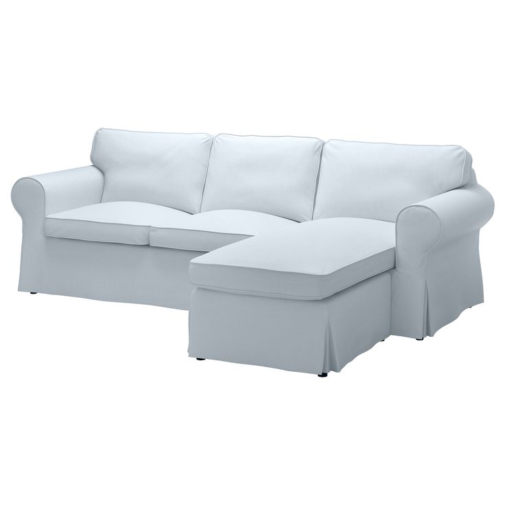 a white couch with a footstool sitting next to it on a white background