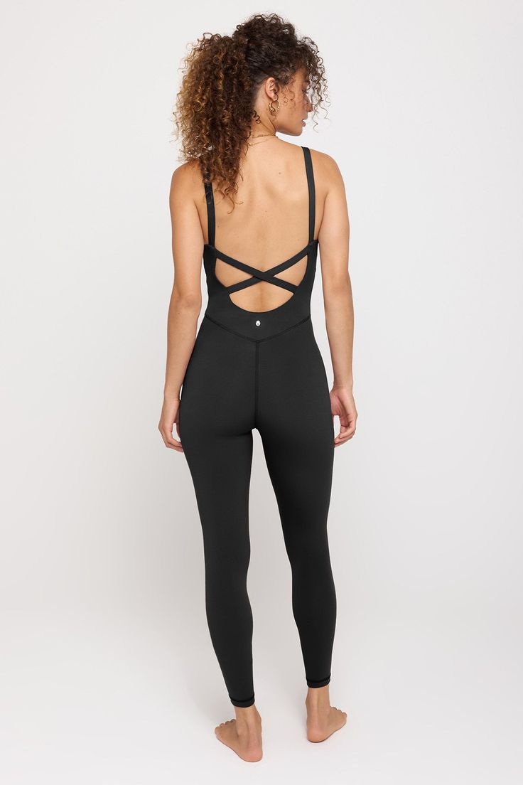 Suit up. A versatile bodysuit designed with double-layered fabric at the chest and cross-back straps with a front peek-a-boo cutout detail. Made in our 4-way stretch Dream Tech eco-conscious fabrication that is compressive, moisture-wicking, quick-drying, and anti-odor. | Olivia 7/8 Bodysuit in Black Fitted Crisscross Activewear With Built-in Bra, Black Cross Back Bodysuit With Built-in Bra, Fitted Activewear With Crisscross Strappy Back, Fitted Activewear With Crisscross Straps And Strappy Back, Fitted Activewear With Crisscross Straps, Stretch Cross Back Bodysuit, Stretch Cross Back Bodysuit For Yoga, Stretch Cross Back Bodysuit For Workout, Compressive Bodysuit With Built-in Bra For Yoga