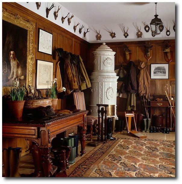 a room filled with lots of deer heads hanging on the wall next to a piano