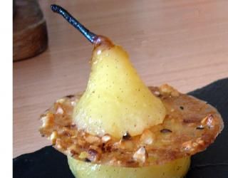 a close up of a banana split in half on a black plate with a wooden table