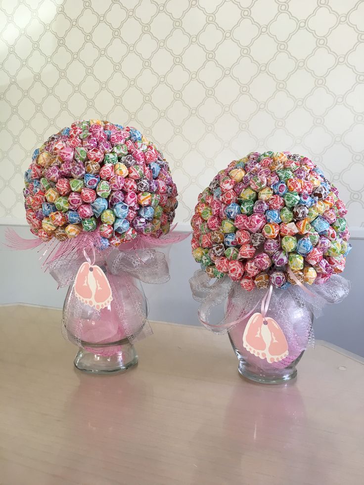 two vases with candy in them sitting on a table