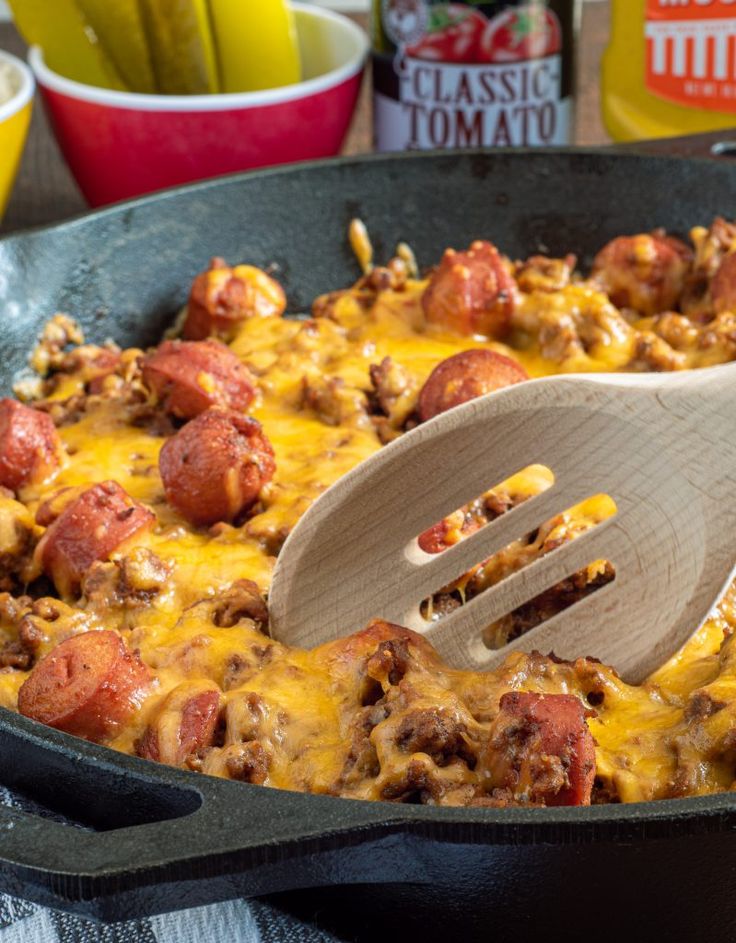 a skillet filled with cheese and meat covered in sauce