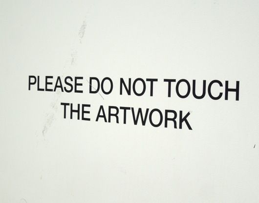 a sign that says please do not touch the artwork