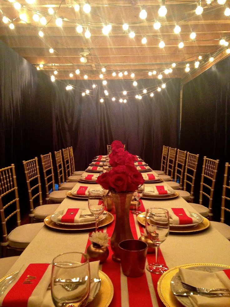 a long table set with red and white place settings