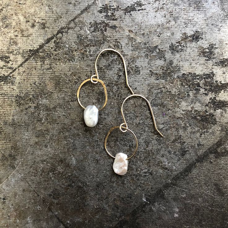 These birthstone earrings are simple, special and sweet. Pearls dangle from a lightly hammered jump ring on handmade earring wires. Pearl is the birthstone for June and symbolizes love, stability and confidence. Length 1/2" Width 1/4" Hammered Drop Pearl Earrings As Gift, Hammered 14k Gold-filled Teardrop Jewelry, Dainty Hammered Jewelry For Everyday, Everyday Hammered 14k Gold Filled Earrings, Simple Adjustable Hammered Jewelry, Minimalist Hammered Teardrop Jewelry, Hand Forged Round Earrings For Anniversary, Simple Hand Forged Sterling Silver Jewelry, White Minimalist Hand Forged Jewelry