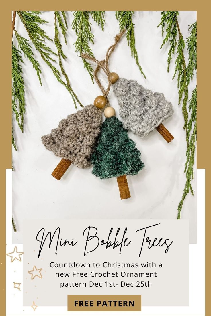 two crocheted christmas trees hanging from a tree branch with the text free pattern