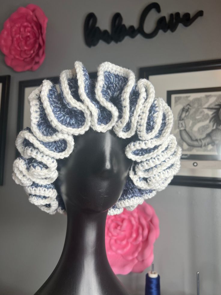 a mannequin head wearing a crocheted hat