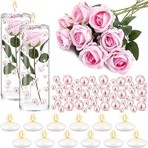 pink roses in a vase with candles and pearls on the table next to each other