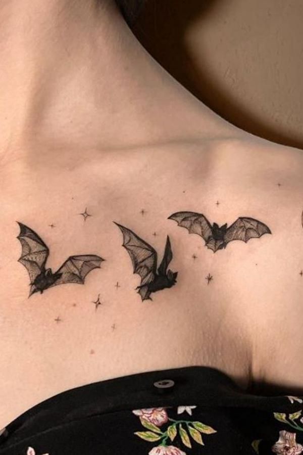 a woman's chest with bats on it and stars in the sky above her