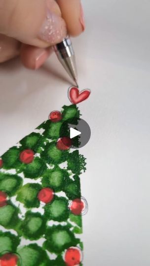 someone is drawing a christmas tree on paper