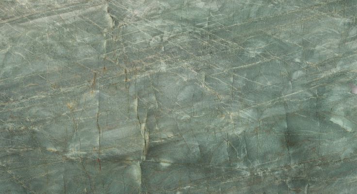 a green marble textured surface with white and black lines on the top, as seen from above