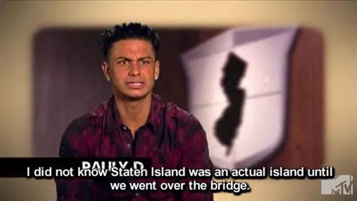 a man standing in front of a sign with the words, i did not know what island was actual island until we went over the bridge