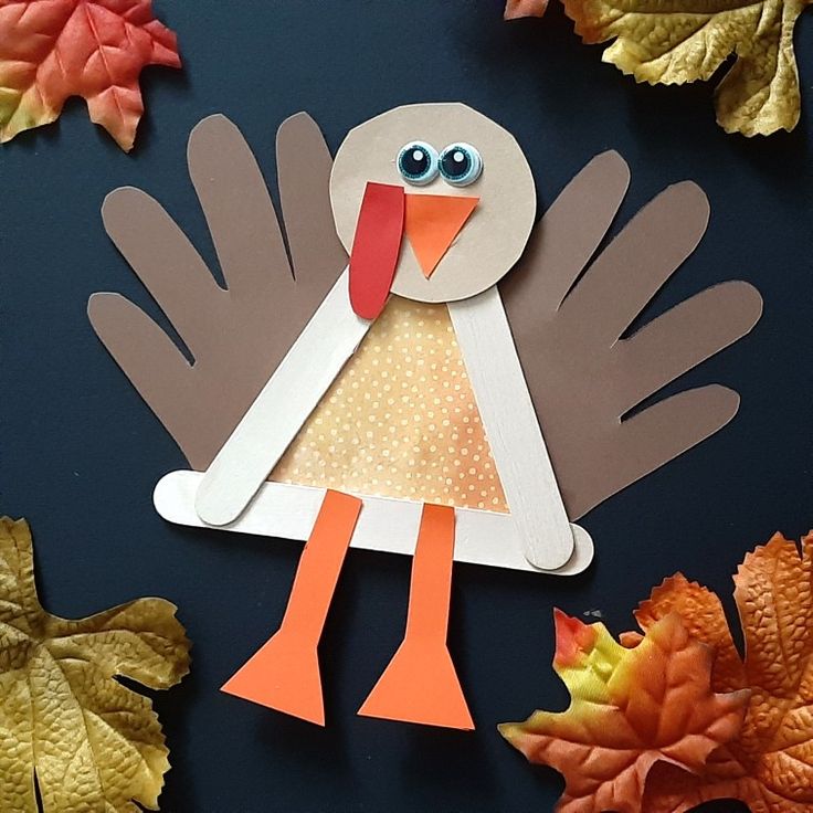 a paper turkey with leaves surrounding it