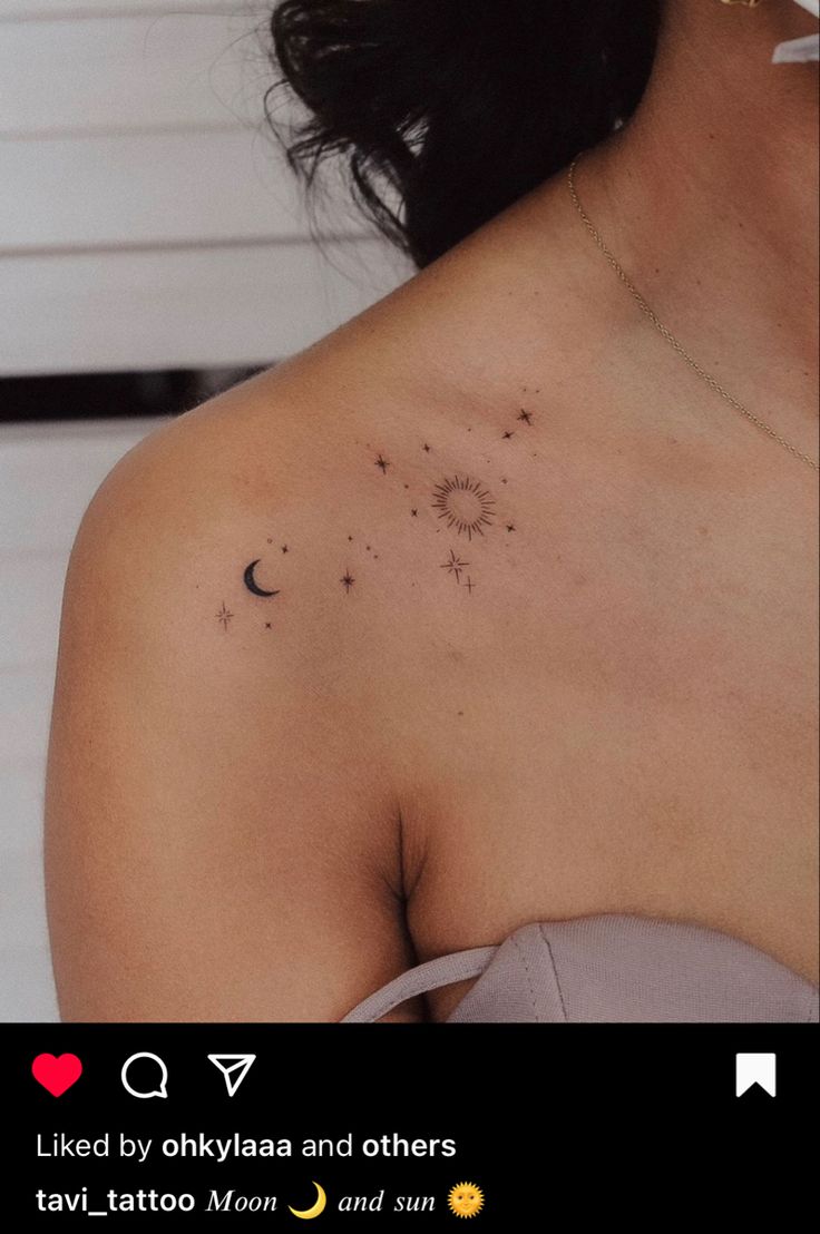 the back of a woman's shoulder with small stars and planets on it