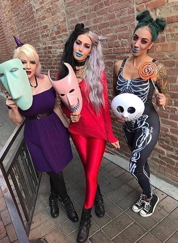 three women dressed in costumes posing for the camera