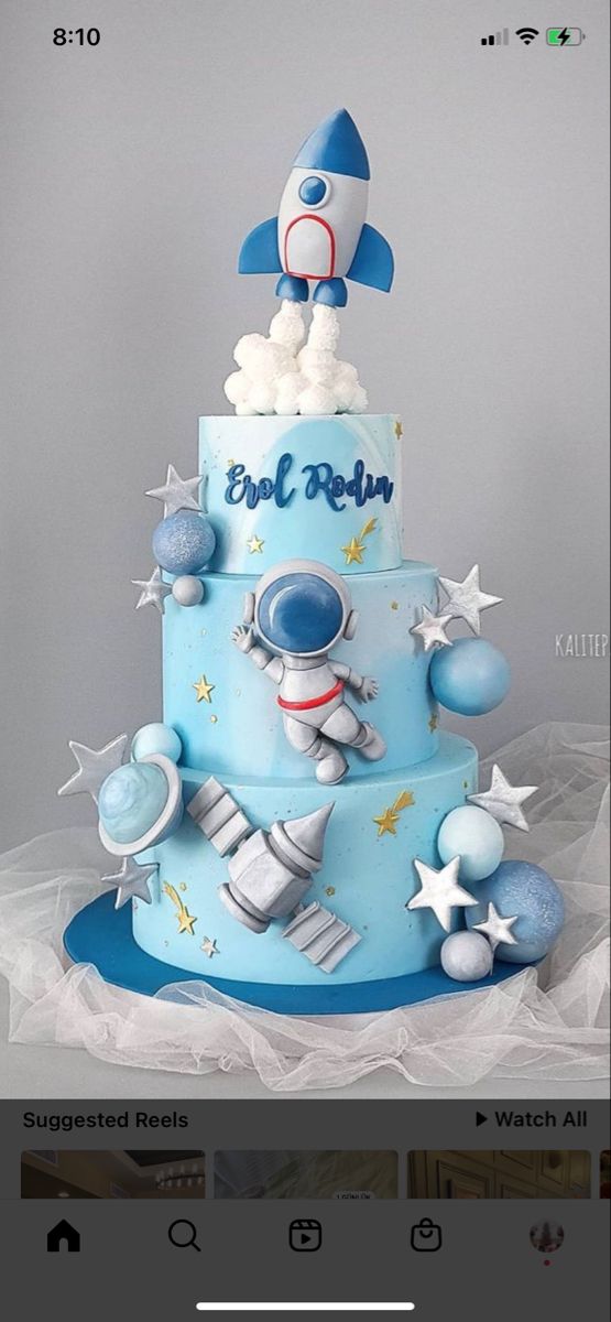 a blue and white cake with a rocket on top