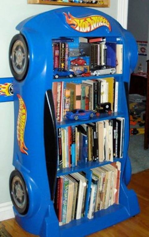 a blue toy car book shelf with books on it