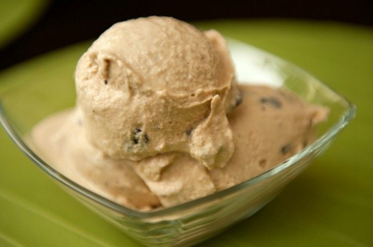 a bowl filled with ice cream on top of a green table