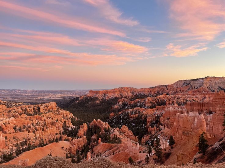 the sun is setting over the canyons in the mountains near hoodoo, utah