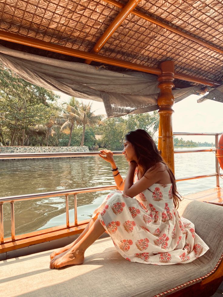 a woman sitting on the back of a boat