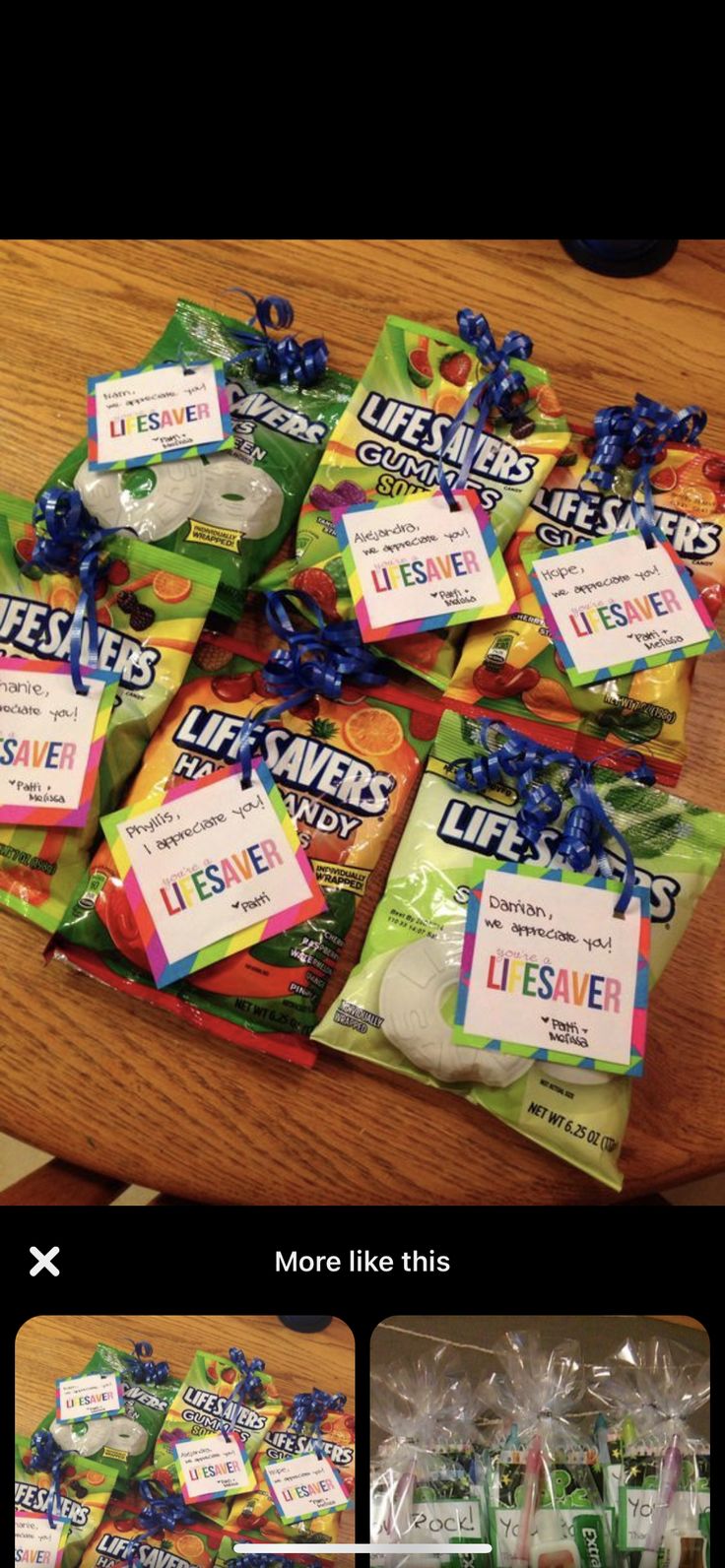 several bags of candy sitting on top of a table next to each other with ribbons around them