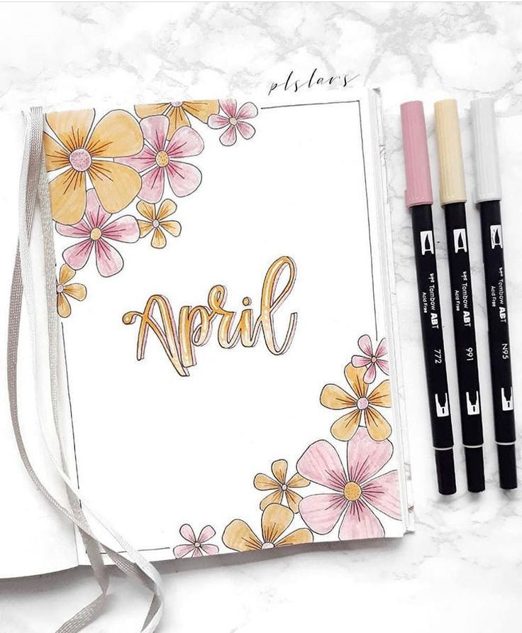 an open notebook with flowers and the word april written in cursive writing