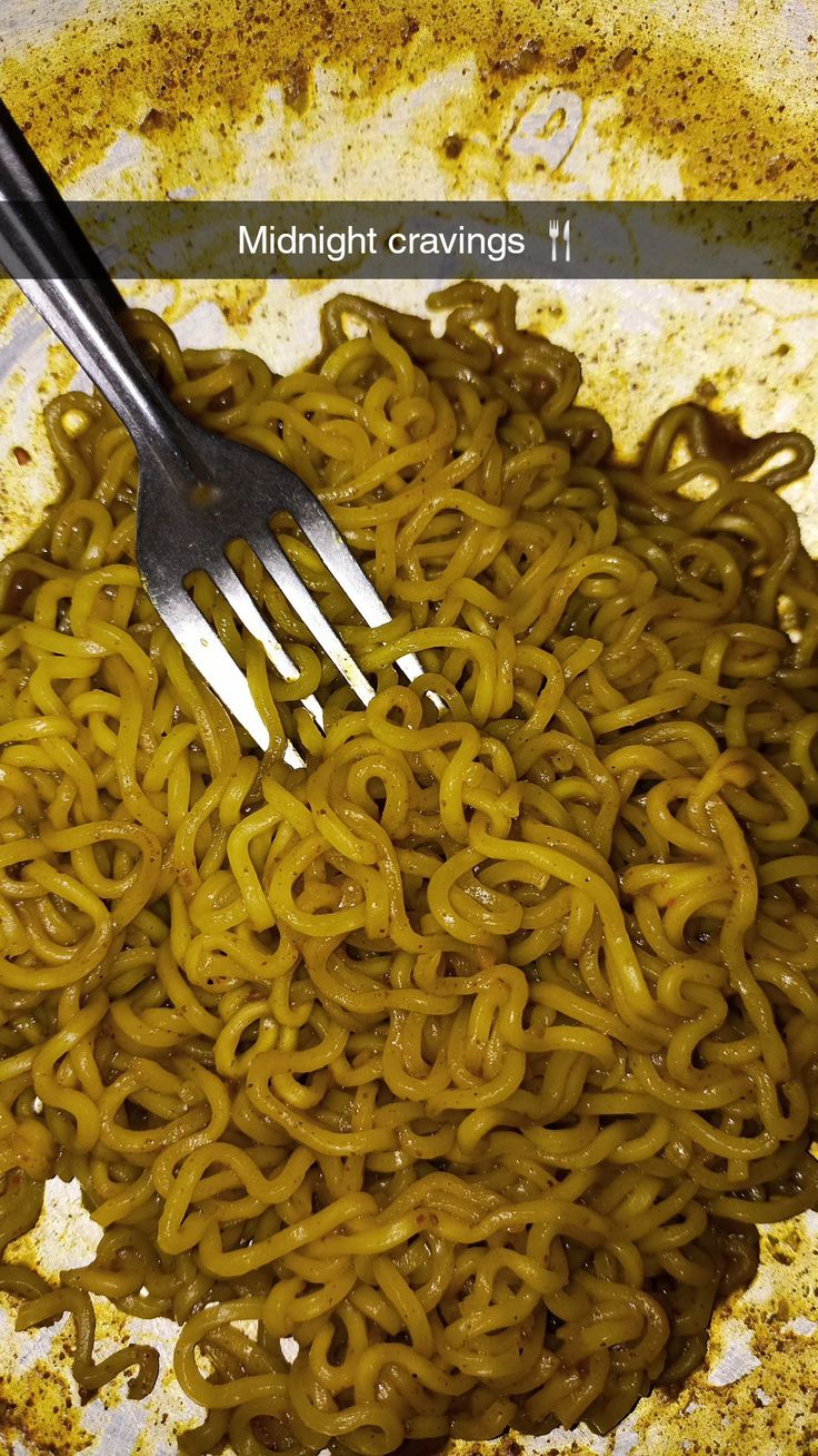 a fork is stuck into some noodles in a bowl