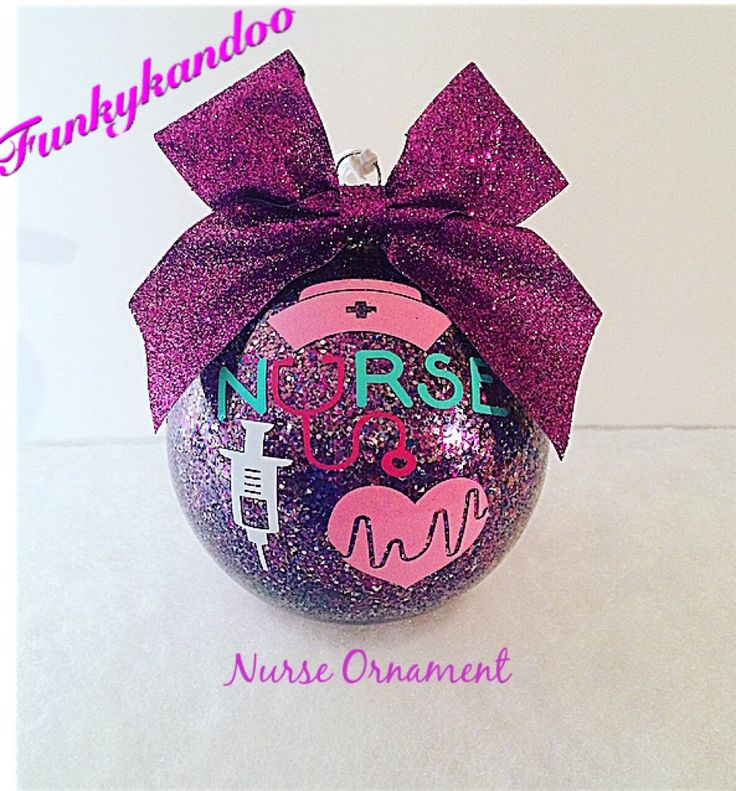 a pink ornament with a purple bow on it