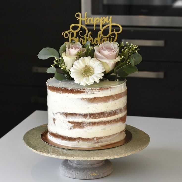 a birthday cake with flowers and the words happy birthday on top